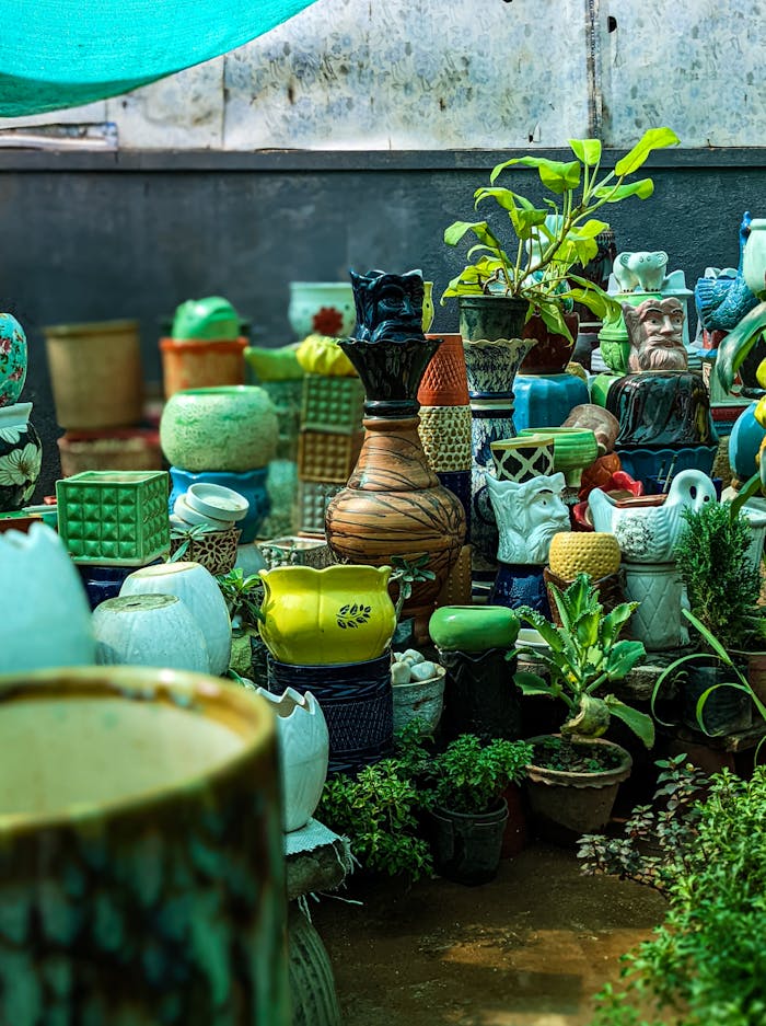Colorful assortment of ceramic pots and vases in a Bengaluru plant nursery.